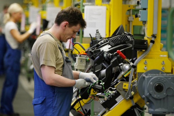 a man working on a machine in a factory.