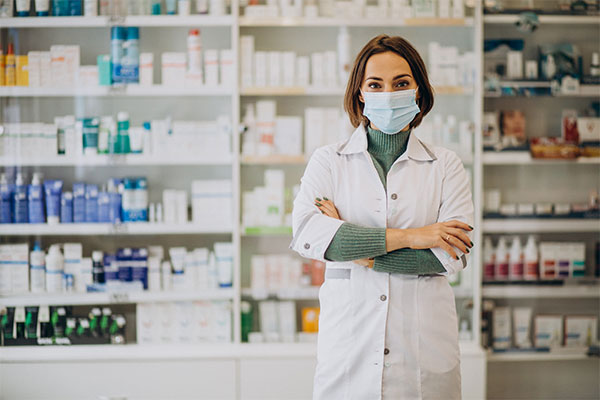 a woman wearing a face mask in a pharmacy.