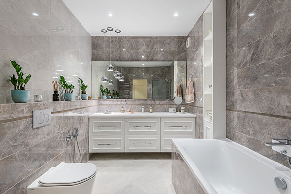 a bathroom with a tub, toilet, sink and mirror.