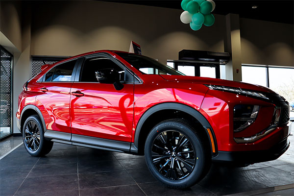 a red suv parked inside of a building.