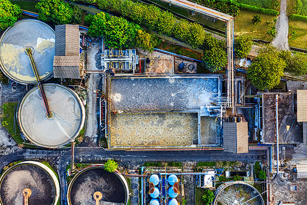 an aerial view of a factory with lots of tanks.